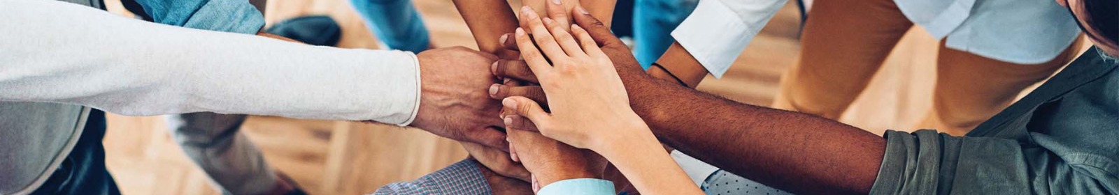 a group of hands piled in the center